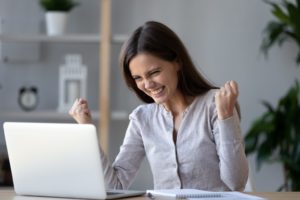 Excited ecstatic teen girl winner celebrating victory success reading admission email with good exam results, happy student rejoicing online win got new job opportunity looking at laptop computer